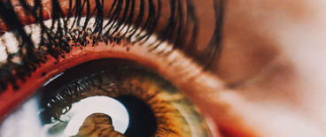 picture of green human eye and eyelash with mascara