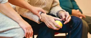 person holding elderly person's wrist