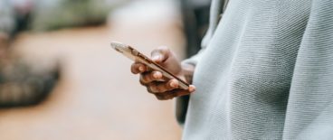 person holding their phone in their right hand