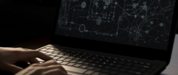 A laptop screen showing dark patterns; a person about to click on something on the screen