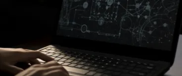 A laptop screen showing dark patterns; a person about to click on something on the screen